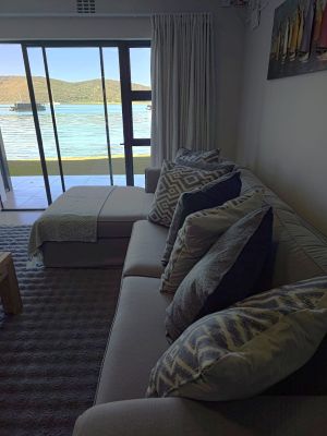 grey couch with boat painting above